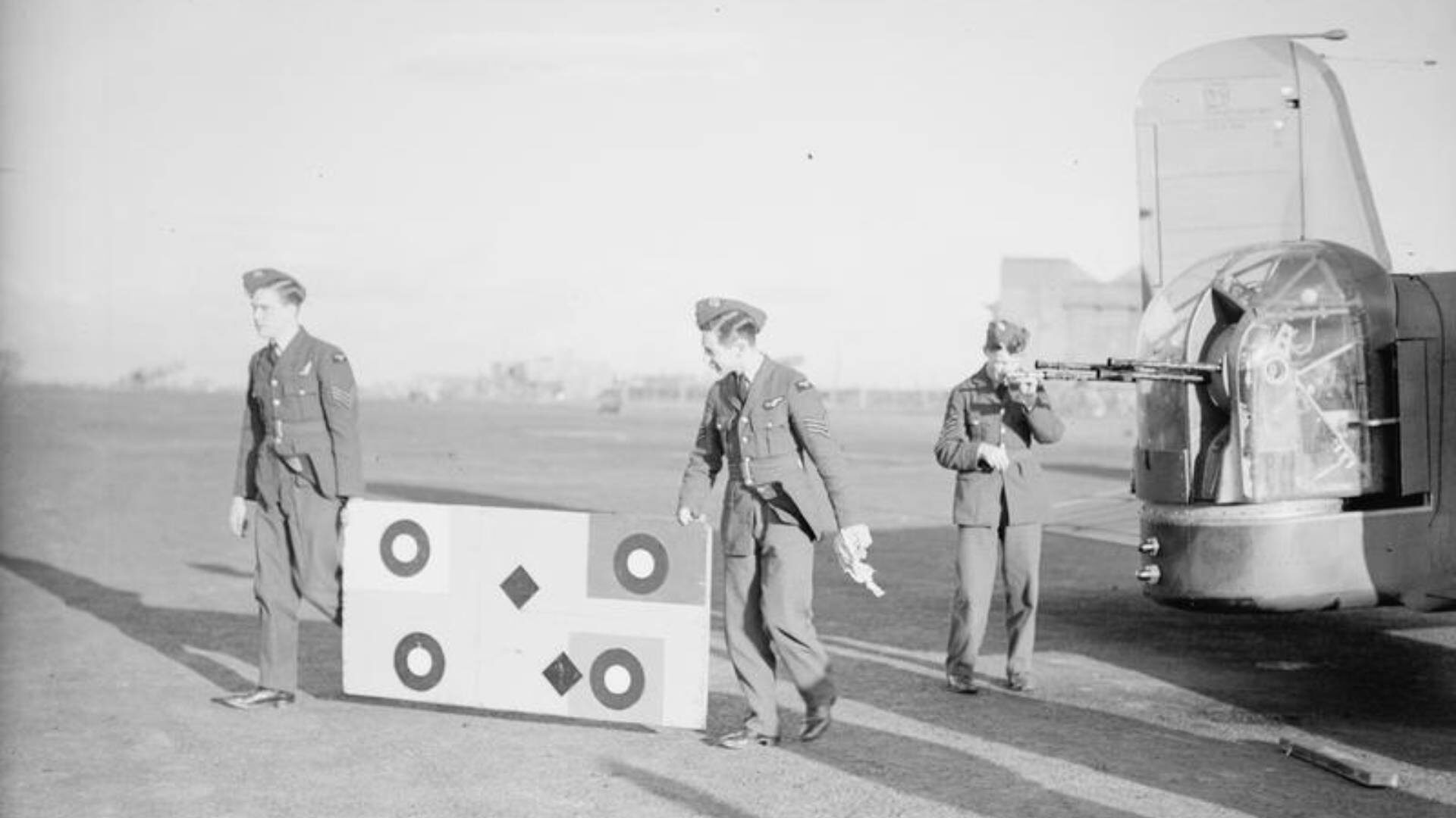 Crew harmonising the gunsights of the tail turret on a Mk. V Armstrong-Whitworth Whitley of RAF 502 (Ulster) Squadron at R.A.F. Aldergrove, Co. Antrim on 18th November 1940