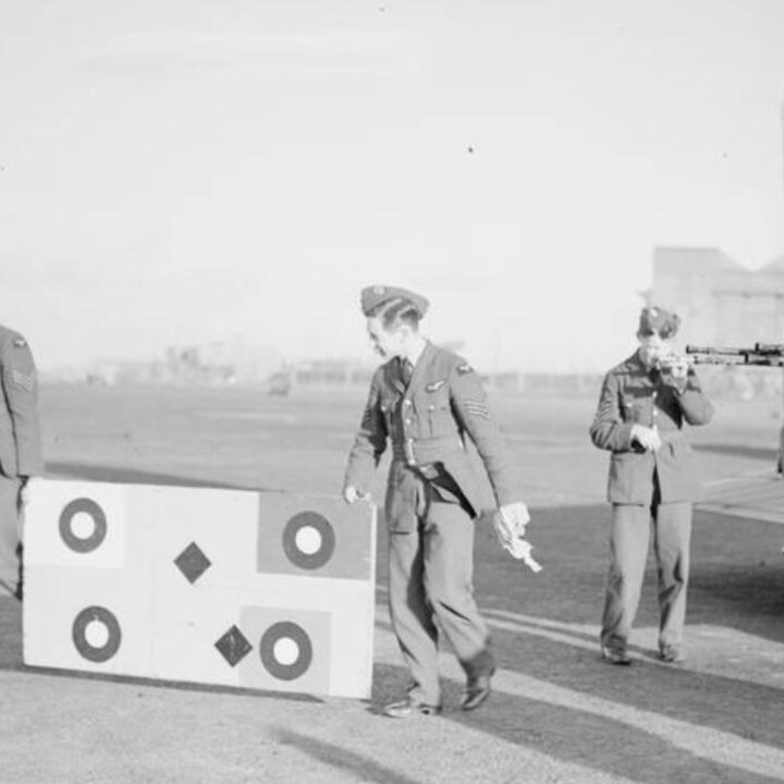 Crew harmonising the gunsights of the tail turret on a Mk. V Armstrong-Whitworth Whitley of RAF 502 (Ulster) Squadron at R.A.F. Aldergrove, Co. Antrim on 18th November 1940