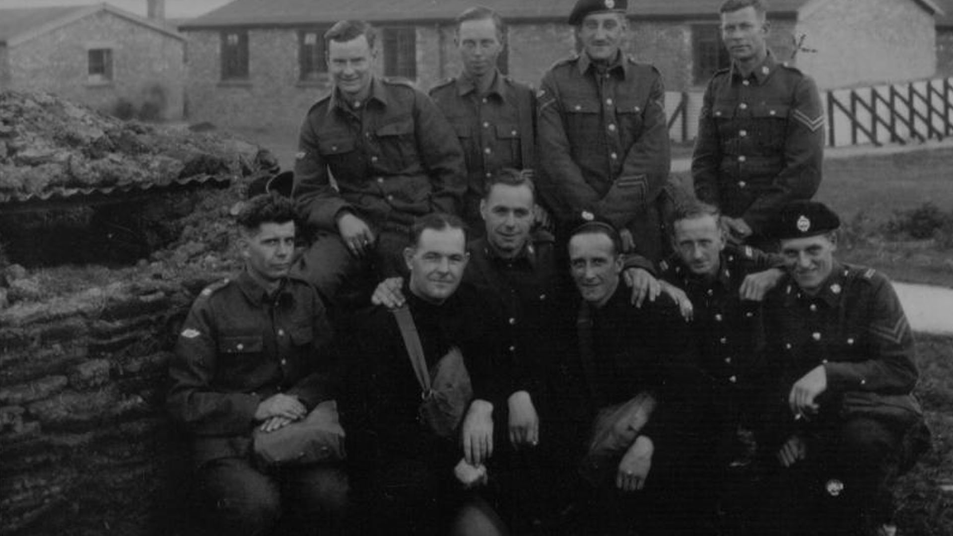 Corporal Alexander Liggett (back row, right-hand-hand side) poses with other members of the Royal Tank Regiment at an unknown location in the United Kingdom.