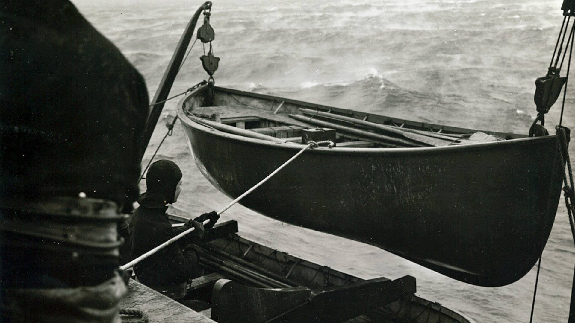 U.S. Soldiers check lifeboats on an Atlantic crossing to Northern Ireland in February 1942