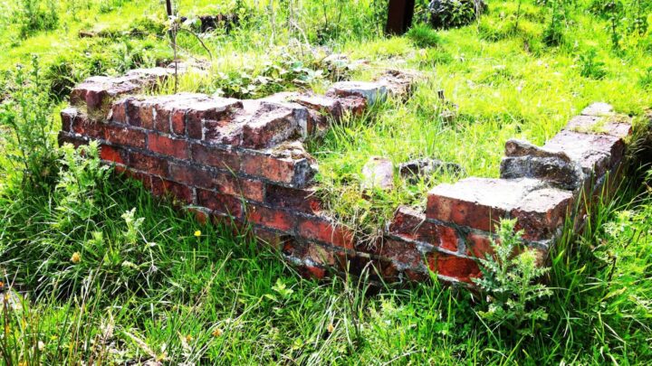 Evidence of structures that made up the Anti-Aircraft Battery at Rocky Road, Lisnabreeny, Belfast includes red brick, concrete, and rusted metalwork.