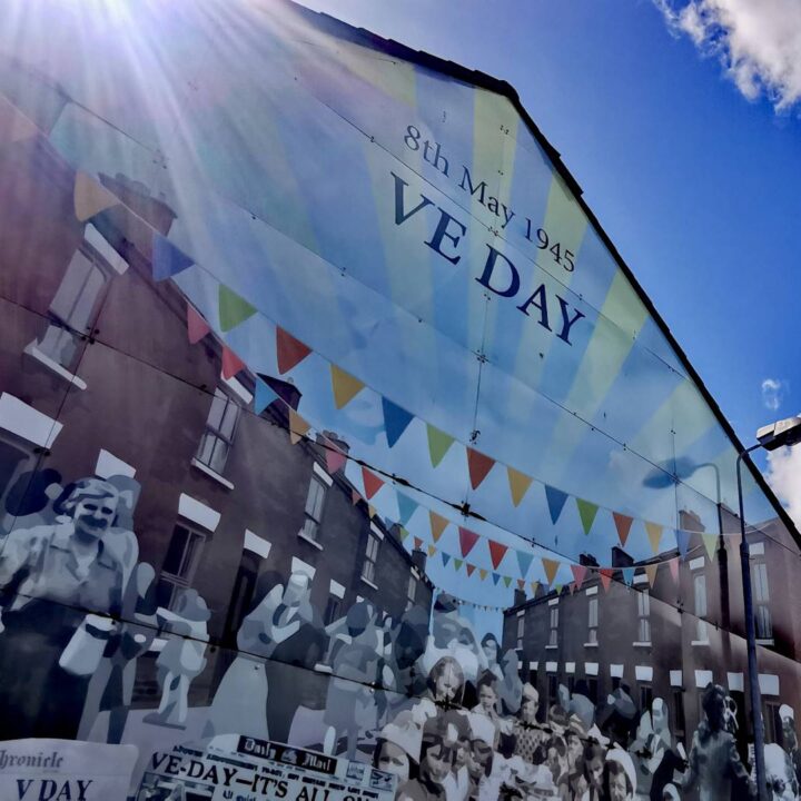 A mural depicting the jubilant scenes within the communities of northwest Belfast on Victory in Europe or V.E Day, 8th May 1945 on Dover Place, Belfast.