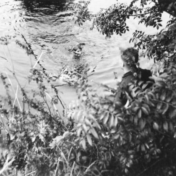 A soldier of 9th Battalion Royal Warwickshire Regiment prepares to swim across a river between Bushmills and Coleraine, Co. Londonderry.