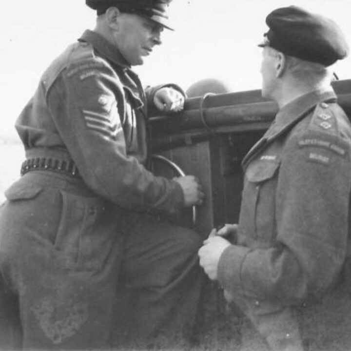 An Ulster Home Guard Motor Boat Patrol helmsman and second-in-charge on a routine inspection of vessels in the waterways around Northern Ireland.