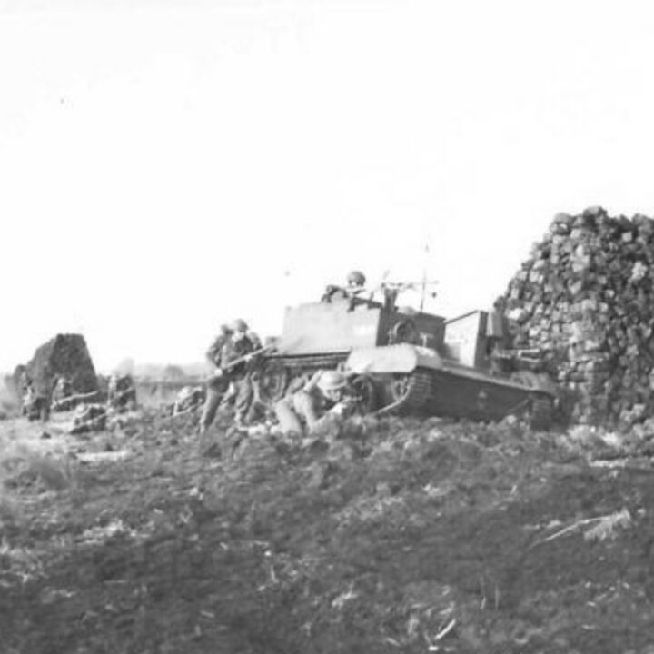 Members of 2nd Battalion, Royal Inniskilling Fusiliers training in a Universal Carrier among the cover of peat stacks in a training exercise on the Bog of Allen near Verner's Bridge, Co. Armagh.