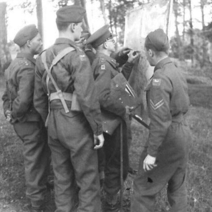 Senior officers and Corps Commander Lieutenant General D.F. Anderson C.B., C.M.G., D.S.O. studying a map of operations at a British Army 3rd Corps training exercise in Northern Ireland.