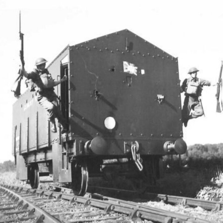 Members of 15th Battalion, South Staffordshire Regiment leaping from a stationary Armoured Rail Trolley of the London, Midland, and Scottish Railway Co. at Whitehead, Co. Antrim.