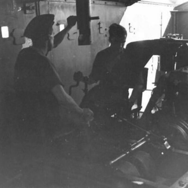Members of 8th Railway Construction and Operating Company inside an Armoured Rail Trolley of the London, Midland, and Scottish Railway at Whitehead, Co. Antrim.