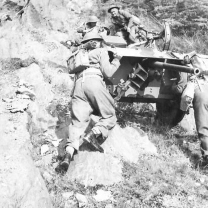 Members of an Anti-Tank Regiment demonstrate methods of transporting guns up a rocky hillside during a training exercise in Northern Ireland.