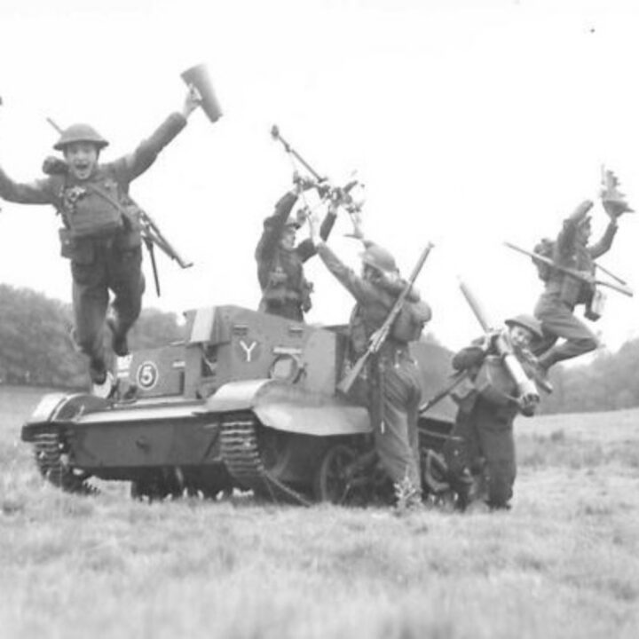 Members of 1st Battalion, Princess Alexandra of Wales’ Own Yorkshire Regiment (The Green Howards) leap from a Universal Carrier carrying parts of a 3” mortar at Omagh, Co. Tyrone.