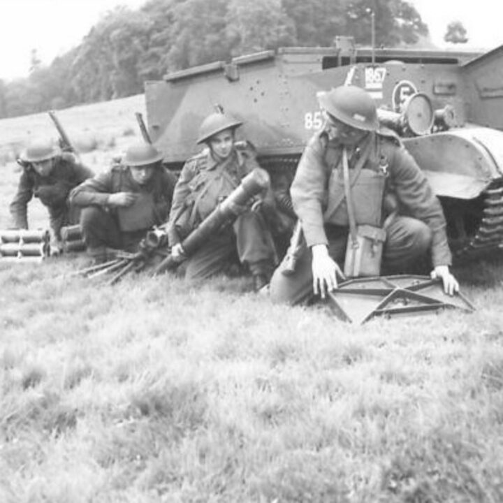 Members of 1st Battalion, Princess Alexandra of Wales’ Own Yorkshire Regiment (The Green Howards) shelter next to a Universal Carrier with an assembled 3” mortar at Omagh, Co. Tyrone.
