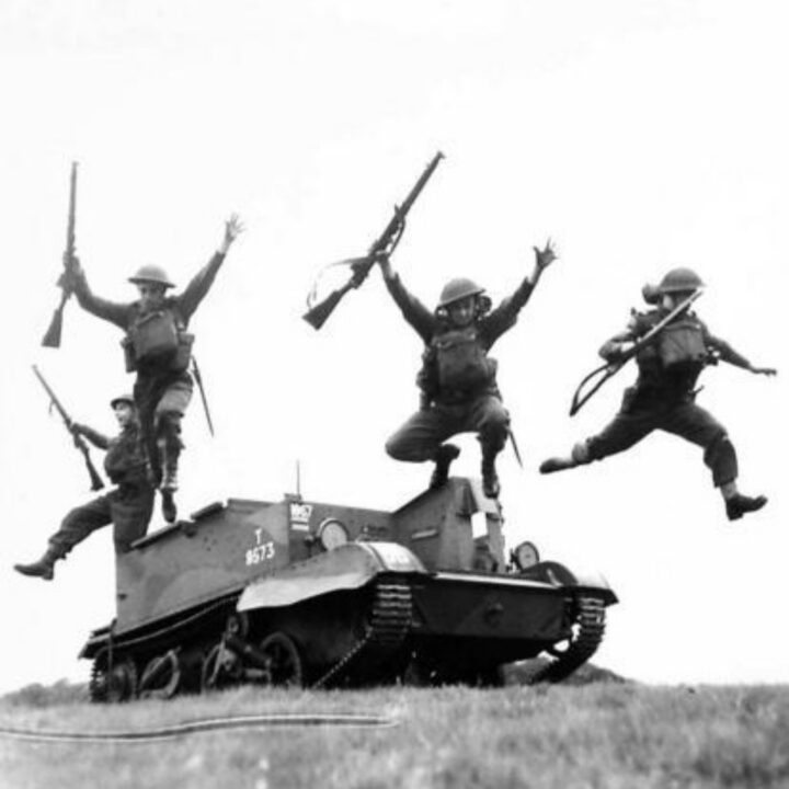 Members of 1st Battalion, Princess Alexandra of Wales’ Own Yorkshire Regiment (The Green Howards) leap from a Universal Carrier at Omagh, Co. Tyrone.