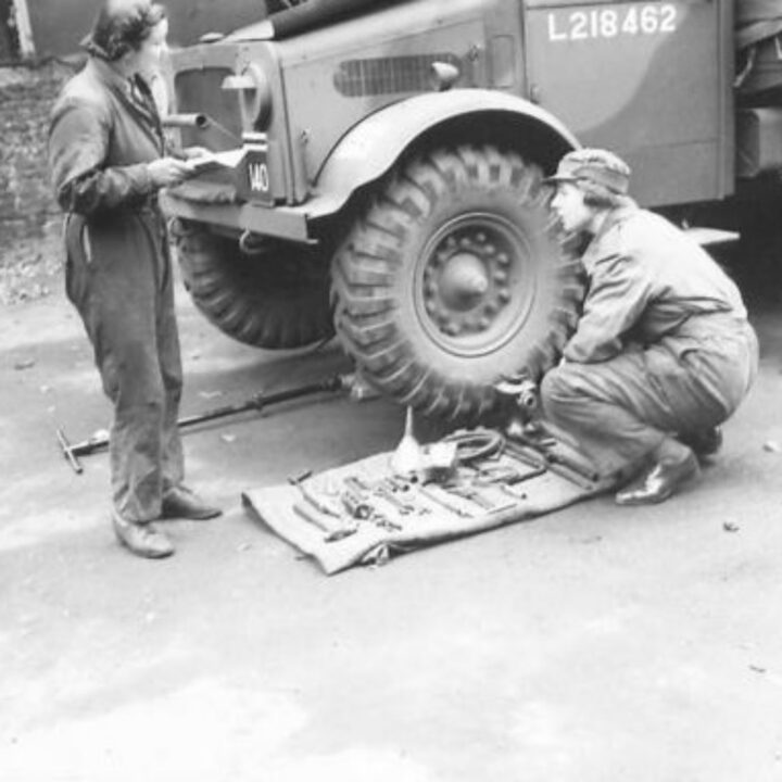 Members of No. 10 Motor Transport Company, Auxiliary Territorial Service carry out maintenance of their truck at Drum House, Drumbeg, Co. Down.