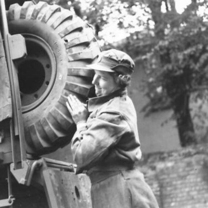 A member of No. 10 Motor Transport Company, Auxiliary Territorial Service carries out maintenance of their truck at Drum House, Drumbeg, Co. Down.