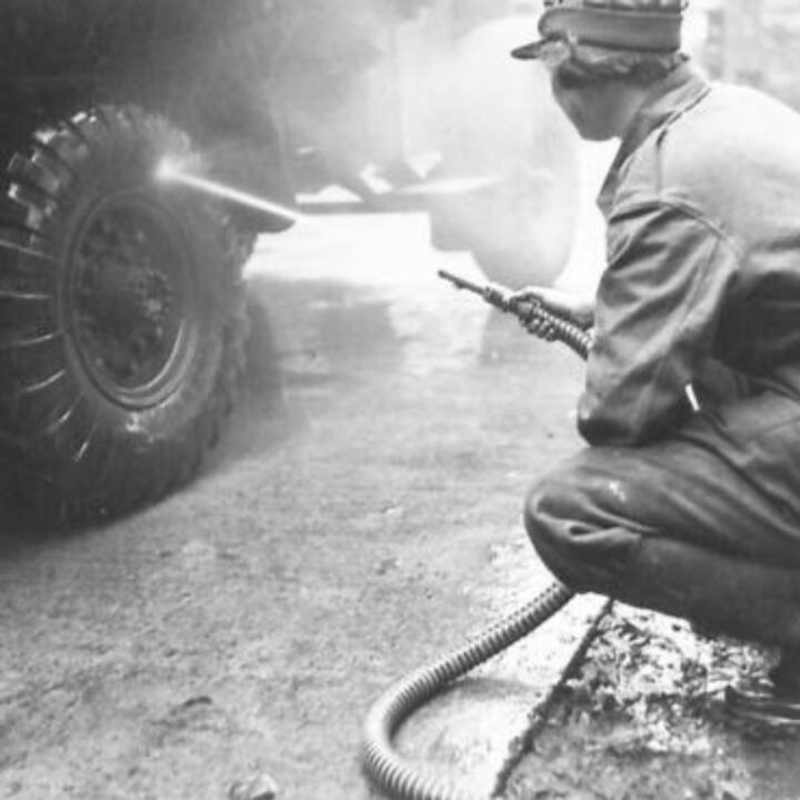 A member of No. 10 Motor Transport Company, Auxiliary Territorial Service carries out maintenance of their truck at Drum House, Drumbeg, Co. Down.
