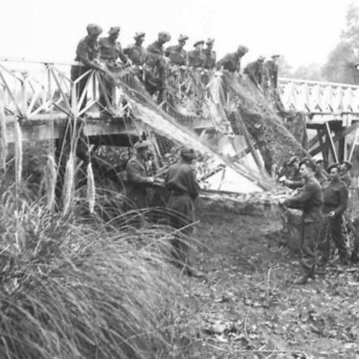 A Motor Transport Company of 6th Battalion, Seaforth Highlanders repair netting over a footbridge within the estate of Crom Castle, Newtownbutler, Co. Fermanagh.