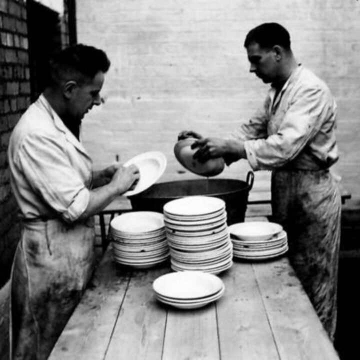 Soldiers wash plates from the mess room at the Royal Army Service Corps depot in Belfast.