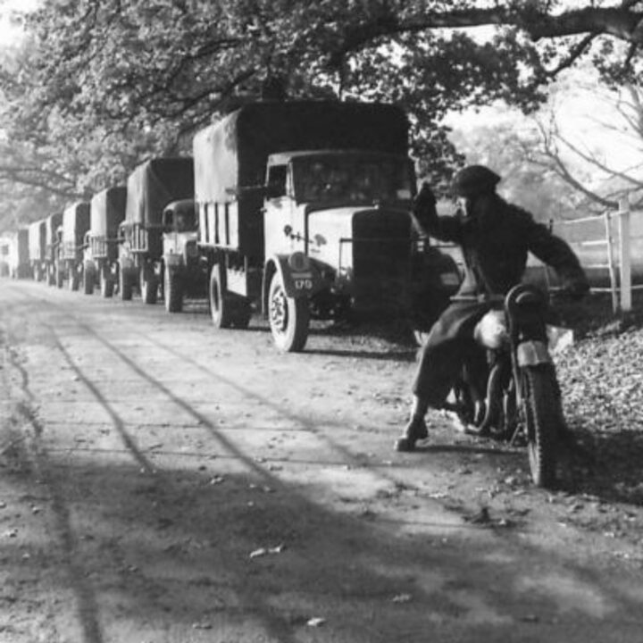 A motorcyclist signals to lorry drivers of an Ulster Home Guard Motor Transport Company in Northern Ireland. At the time, it was thought to be the only such company in the United Kingdom.
