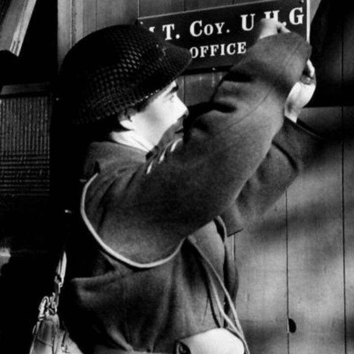 A soldier erects an office notice board at the headquarters of an Ulster Home Guard Motor Transport Company in Northern Ireland. At the time, it was thought to be the only such company in the United Kingdom.