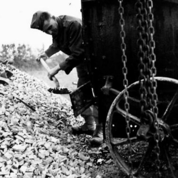 A member of The Pioneer Corps prepares a tar boiler while carrying out road repair work in Northern Ireland.