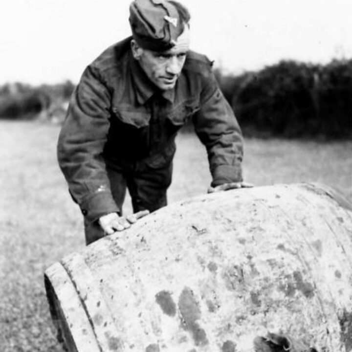 A member of The Pioneer Corps rolls a barrel of tar into position while carrying out road repair work in Northern Ireland.