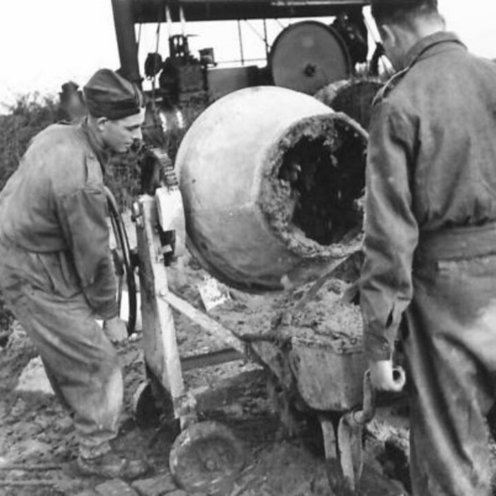 Members of The Pioneer Corps at work with a cement mixer in Northern Ireland.
