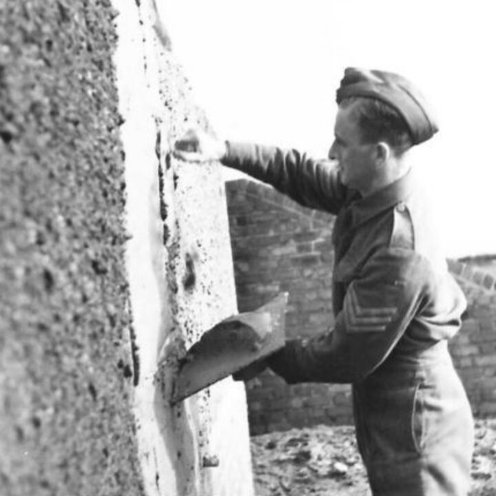 A Sergeant of The Pioneer Corps carrying out the job of plastering in Northern Ireland.