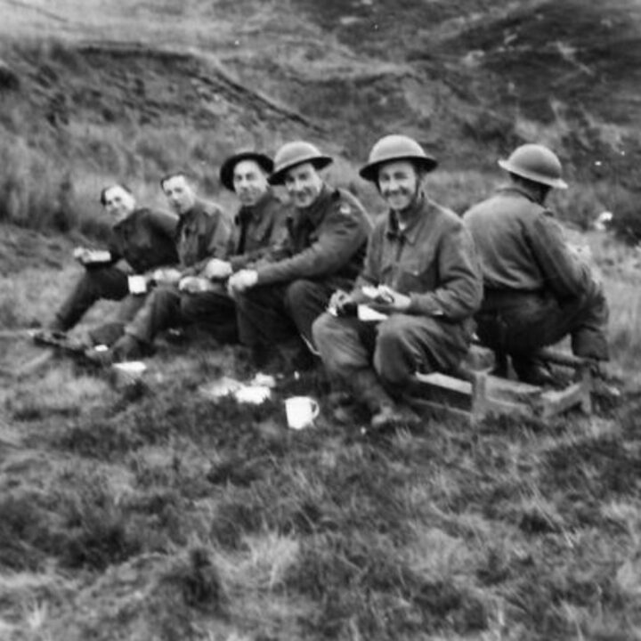 Members of 61st Divisional Engineers cutting a new road through the Sperrin Mountains at Templemoyle, south of Dungiven, Co. Londonderry. The soldiers break for a mid-day meal.