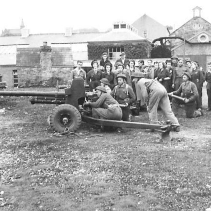 Royal Artillery soldiers from a gun demonstration team run through a drill with a 6-pounder Anti-Tank Gun for munition workers from a factory in Northern Ireland.
