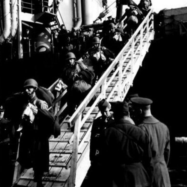 British and American Military Police guard the gangway as American troops disembark a transport vessel in Belfast.