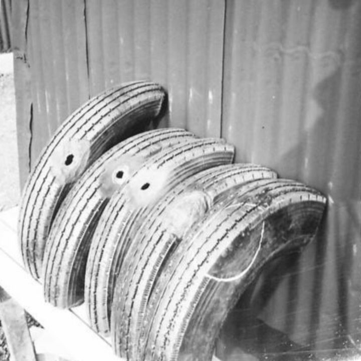 An exhibit stand of tyres ranging from damaged to repaired at an Army Salvage Exhibition in Northern Ireland photographed for O.S.12 War Office.