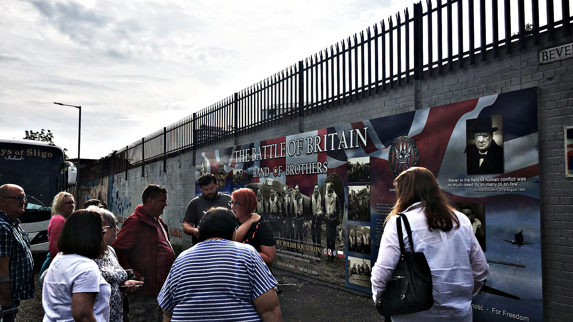 Michael Avila of For Your Freedom and Ours leads a tour of murals commemorating the role of Polish forces during the Second World War. The tour pauses at the 'Band of Brothers' mural on Beverley Street, Belfast.