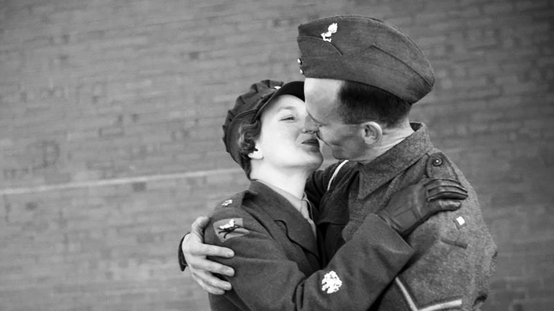 Staff Sergeant Mabel Kathleen Twist, thought to be the only person of her rank in Northern Ireland was commended by Auxiliary Territorial Service Chief Controller Jean Knox as the 'smartest woman in the A.T.S.'. She is embraced by her husband Lance Bombardier Twist, on leave from England.
