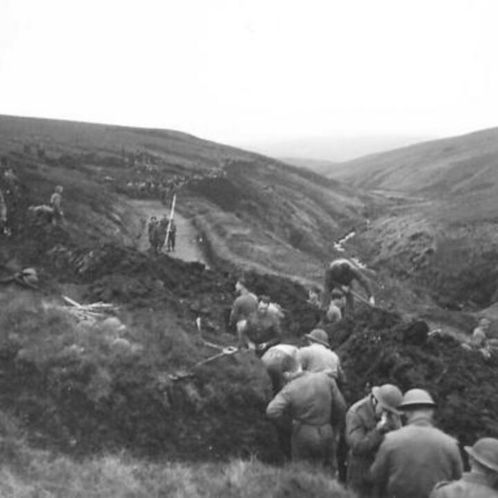 Members of the 61st Divisional Engineers cutting a new road through the Sperrin Mountains at Templemoyle, south of Dungiven, Co. Londonderry. Sappers stack peat by the roadside to drain.