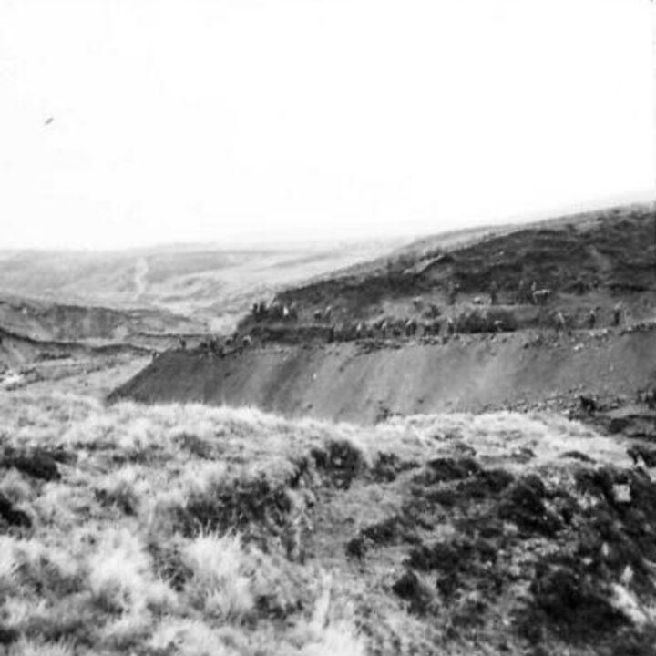 Members of the 61st Divisional Engineers cutting a new road through the Sperrin Mountains at Templemoyle, south of Dungiven, Co. Londonderry. Part 1 of 2 of a panorama of the winding road.