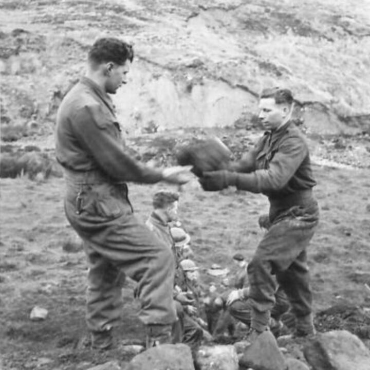 Members of 297, 582, 583, and 584 Companies, Kent Corps Troops, Royal Engineers cutting a new road through the Sperrin Mountains and Templemoyle, south of Dungiven, Co. Londonderry. Soldiers handling stones from the stream bed.