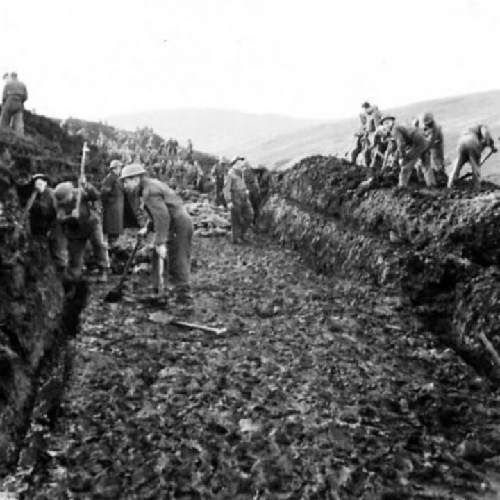 Members of 297, 582, 583, and 584 Companies, Kent Corps Troops, Royal Engineers cutting a new road through the Sperrin Mountains and Templemoyle, south of Dungiven, Co. Londonderry. Soldiers at work on a section of the new road.