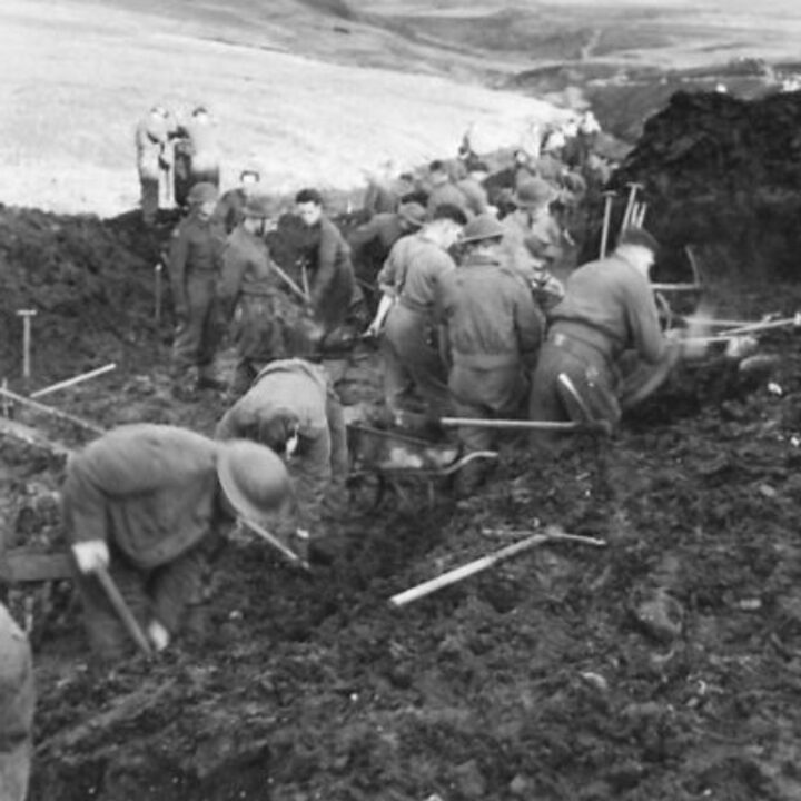 Members of 297, 582, 583, and 584 Companies, Kent Corps Troops, Royal Engineers cutting a new road through the Sperrin Mountains and Templemoyle, south of Dungiven, Co. Londonderry. Soldiers working at the head of the road.