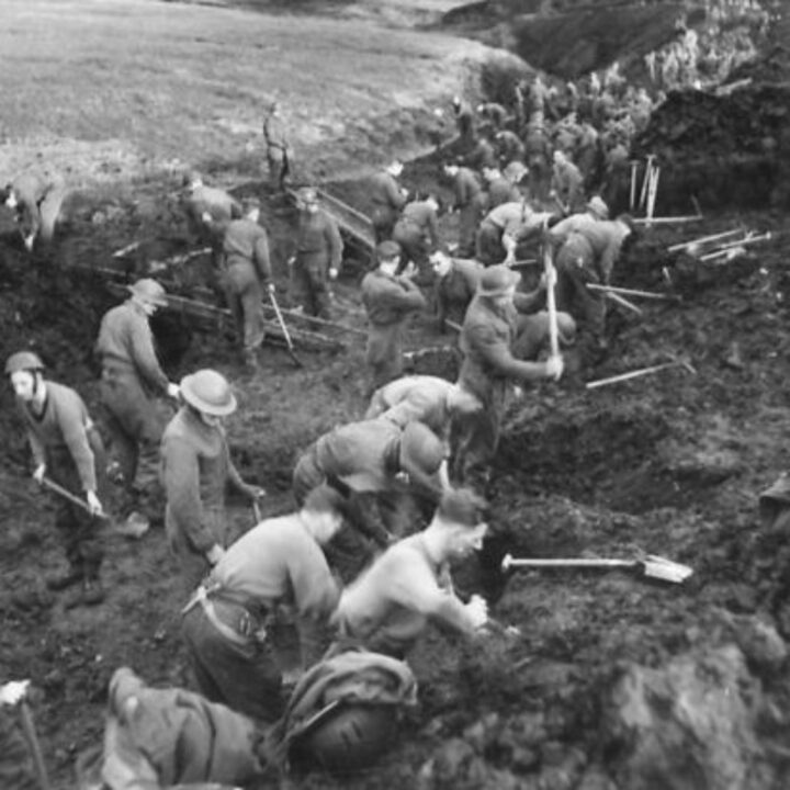 Members of 297, 582, 583, and 584 Companies, Kent Corps Troops, Royal Engineers cutting a new road through the Sperrin Mountains and Templemoyle, south of Dungiven, Co. Londonderry. Soldiers working on the construction of the new road as far as the eye can see.