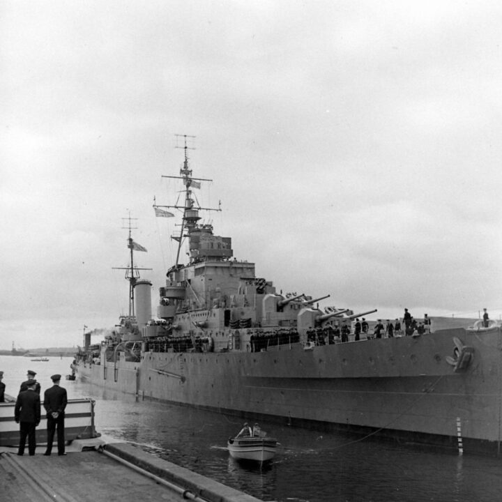 The Dido-class cruiser H.M.S. Phoebe draws alongside the quay in Musgrave Channel, Belfast.