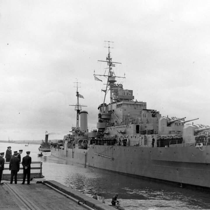 The Dido-class cruiser H.M.S. Phoebe draws alongside the quay in Musgrave Channel, Belfast.