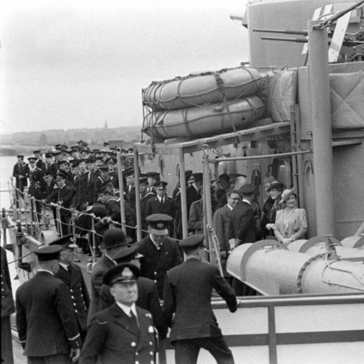 King George VI and Queen Elizabeth on the deck of Dido-class cruiser H.M.S. Phoebe on their arrival at Musgrave Channel, Belfast.