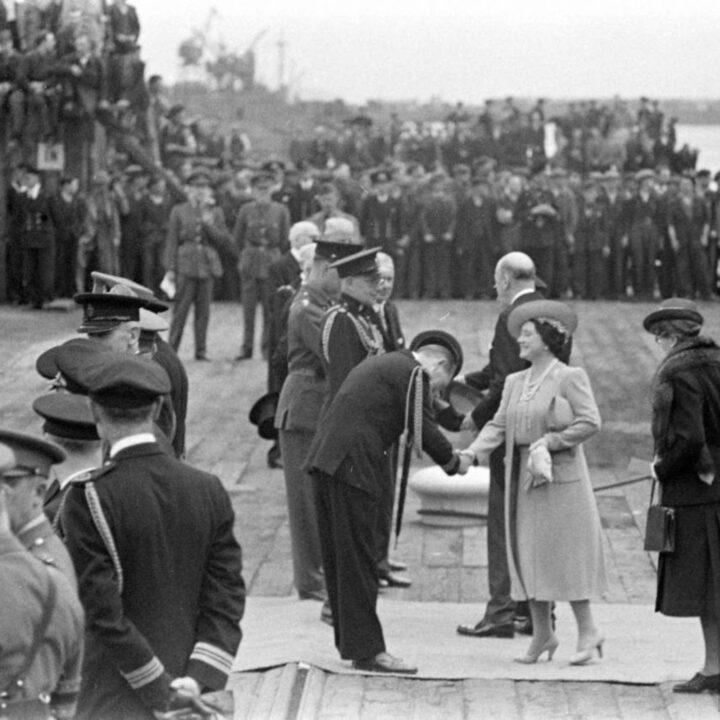 Rear Admiral Richard Matthew King D.S.O. (Flag Officer in Charge Belfast. H.M.S. Caroline) formally greets Queen Elizabeth. Immediately behind the Queen are the Duchess of Abercorn and Home Secretary Herbert Morrison.