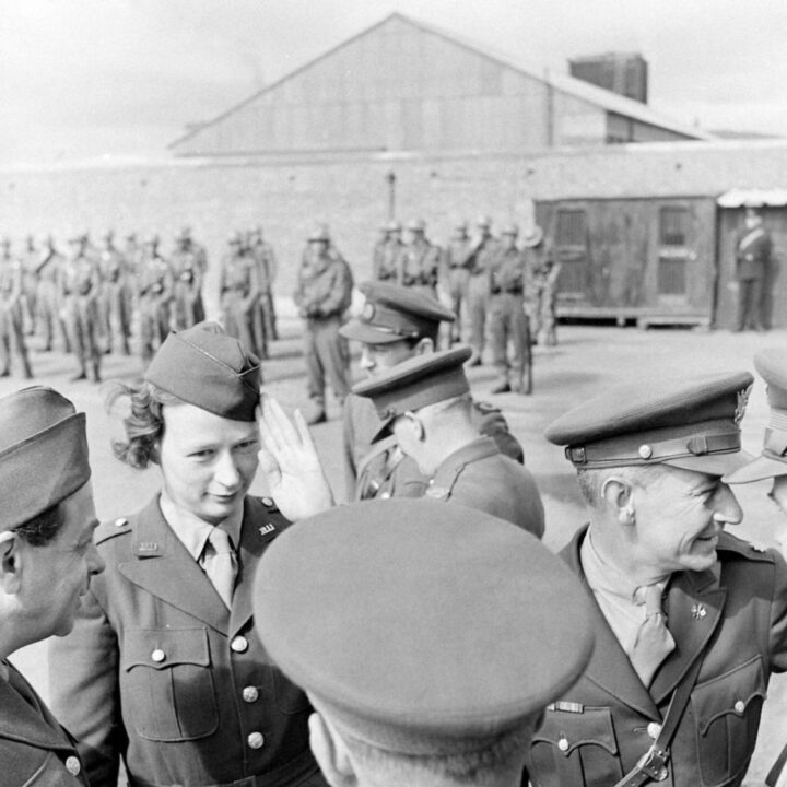 American-born war correspondent Helen Kirkpatrick of the Chicago Daily News salutes a group of British and American military officers near Musgrave Channel, Belfast.