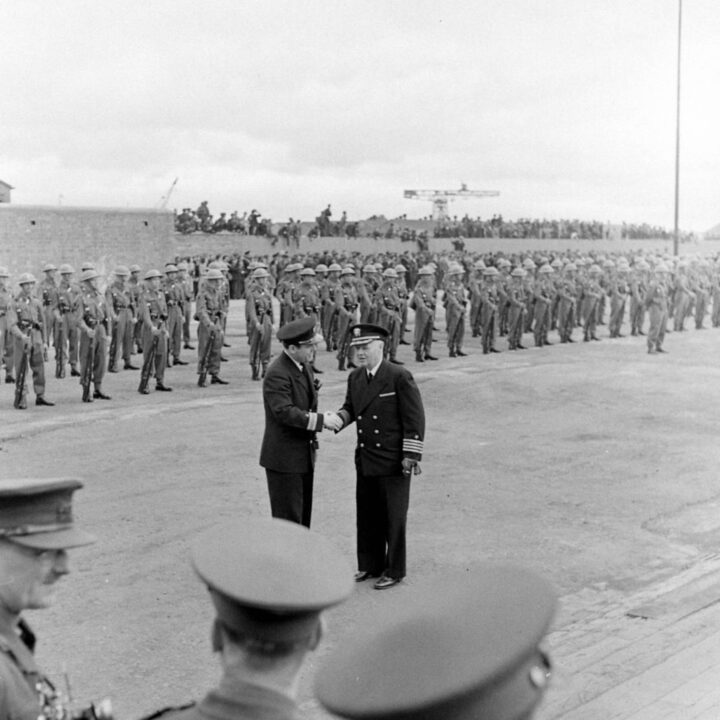 Captain William J. Larson (Commandant of the U.S. Naval Operating Base, Derry~Londonderry) greets another Royal Naval officer in front of a guard of honour from 30th Battalion, Royal Ulster Rifles near Musgrave Channel, Belfast.