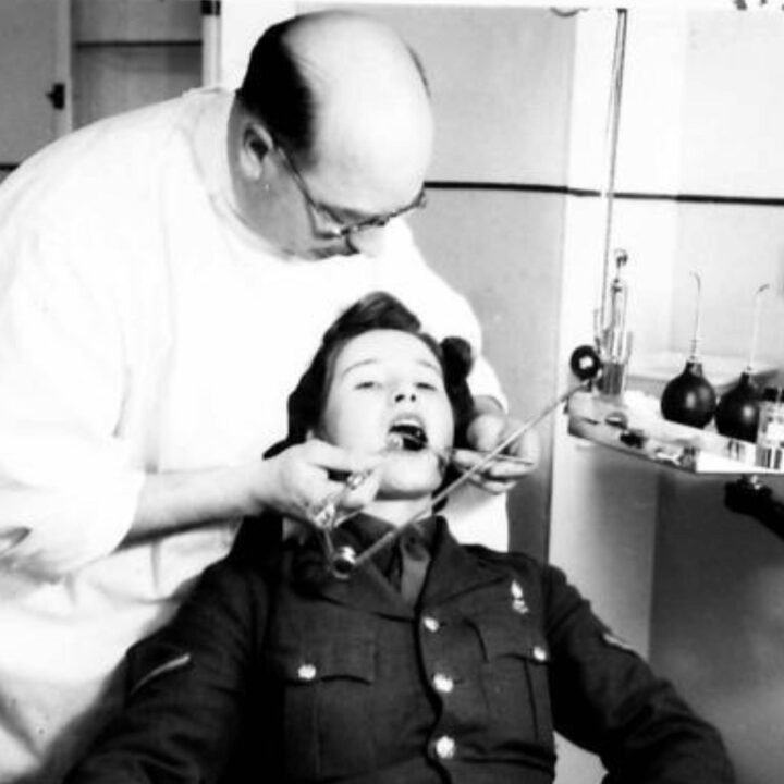 A military dentist providing routine treatment to a member of the A.T.S. at an Army Dental Centre at 389-391 Antrim Road, Belfast. Such centres provide a service to the British Army and the Auxiliary Territorial Service that usually only the wealthy could afford.