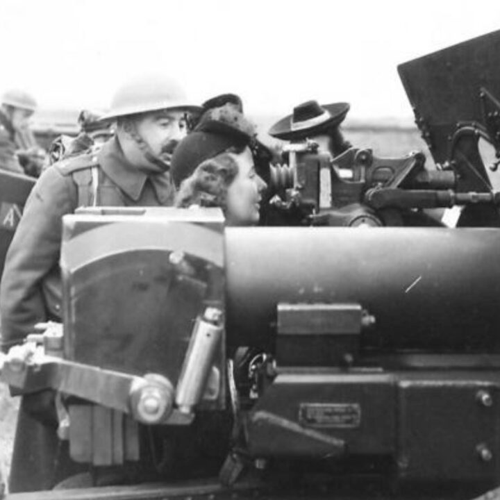 Workers from a munitions factory in Northern Ireland receive instruction on laying the guns with 243rd Battery, 116 Field Regiment, Royal Artillery at Downpatrick, Co. Down.