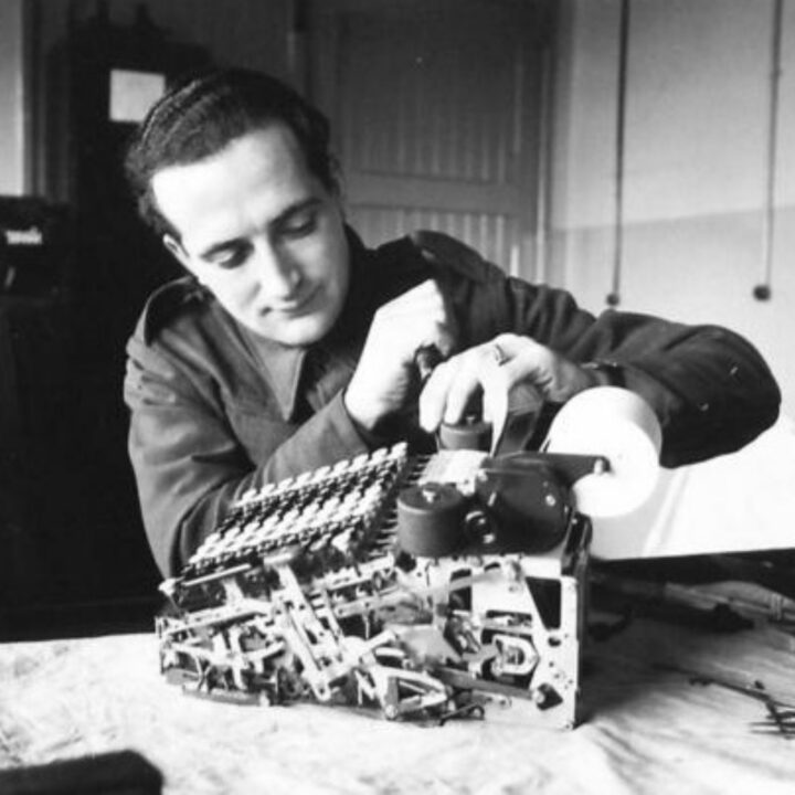 Craftsman Lewis of Bournemouth, England attending to a Burroughs Adding Machine at a Royal Electrical and Mechanical Engineers base workshop at Kinnegar Barracks, Holywood, Co. Down.