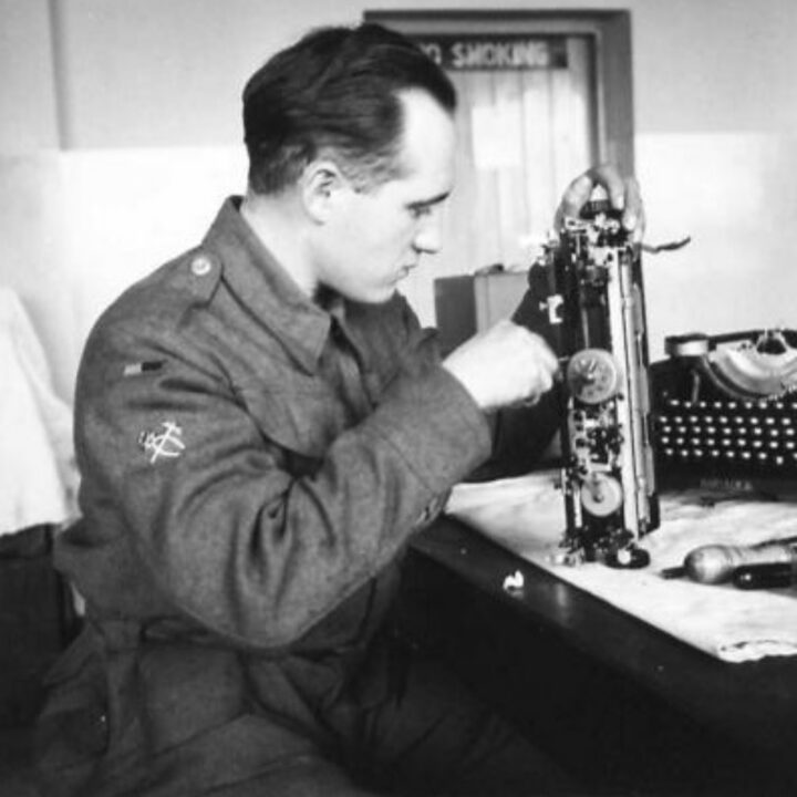 Craftsman Crimp of Bermondsey, Londond, England repairing an army typewriter at a Royal Electrical and Mechanical Engineers base workshop at Kinnegar Barracks, Holywood, Co. Down.