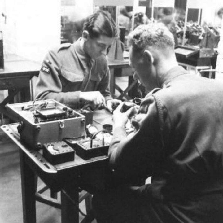 Craftsman Ellis of Llanfyllin, Montgomeryshire, Wales and Craftsman Collins of Liverpool, England at work on delicate wireless radio equipment at a Royal Electrical and Mechanical Engineers base workshop at Kinnegar Barracks, Holywood, Co. Down.